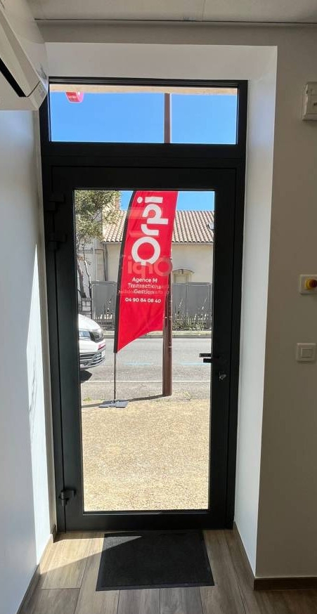 Pose d'une porte d'entrée en alu vitrée pour une agence immobilière sur Montfavet
