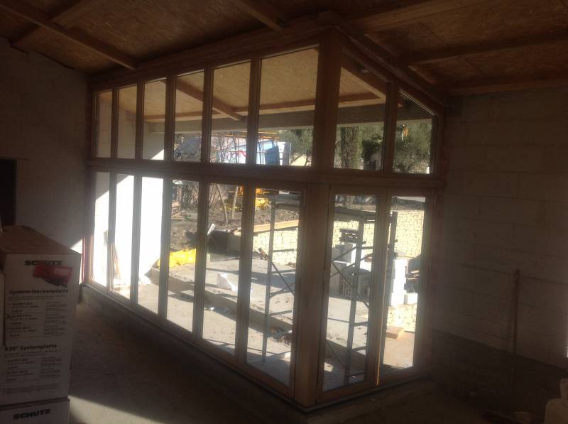 Baie coulissante en accordéon avec rail encastré en bois mélèze et aluminium anthracite dans le 84