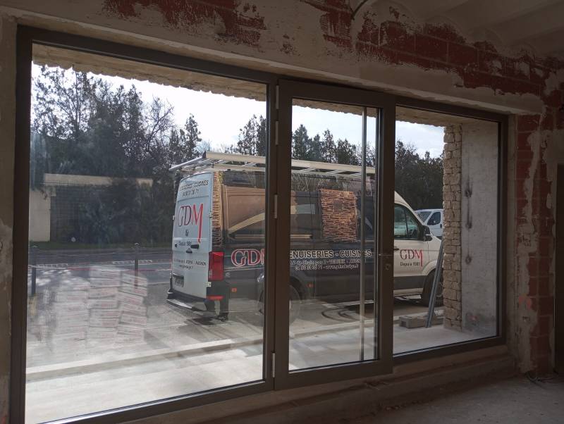 POse d'une porte d'entrée vitrée pour un magasin avec 2 fenêtres fixes en aluminium sur mesure dans le 84 (Coustellet)